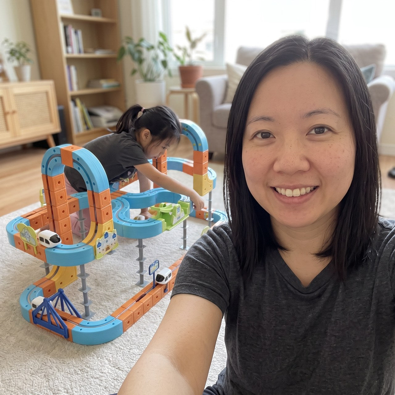 Emma taking a living-room selfie beside her daughter’s railway